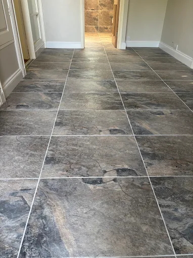 Large format slate effect floor tiling through a hallway